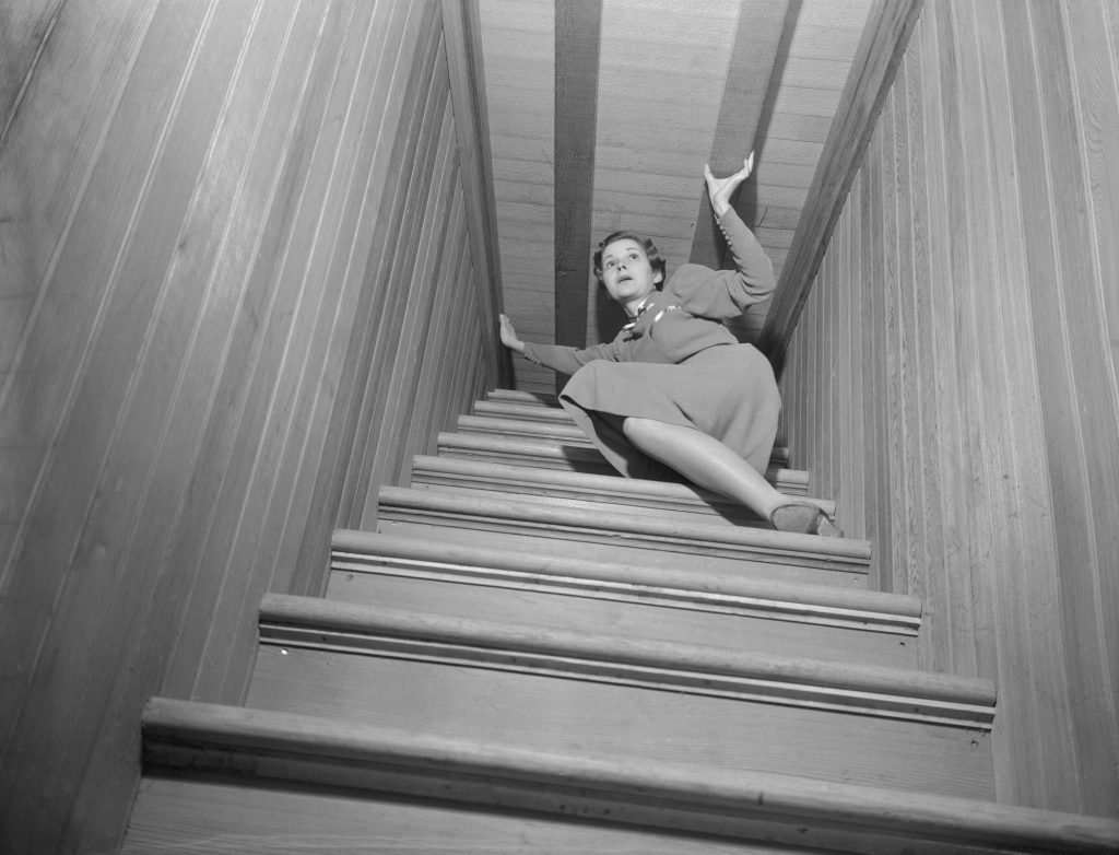 An illustrative photo. A woman is stuck at the top of a stairway which doesn't go anywhere.